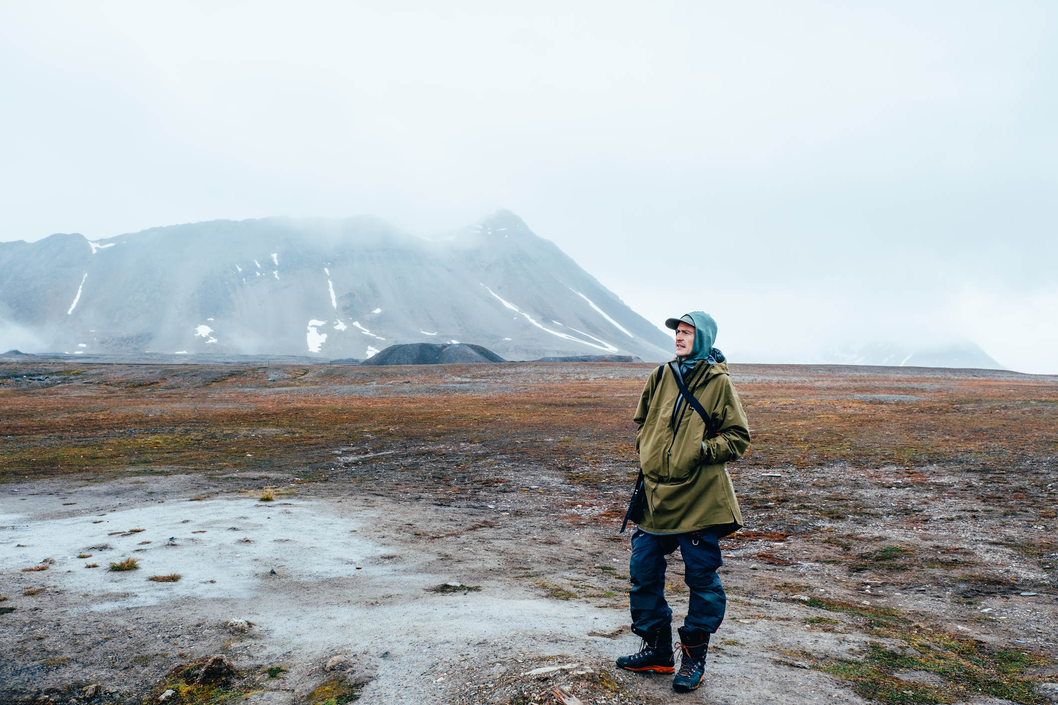 Man looking out at mountains in Svalbard