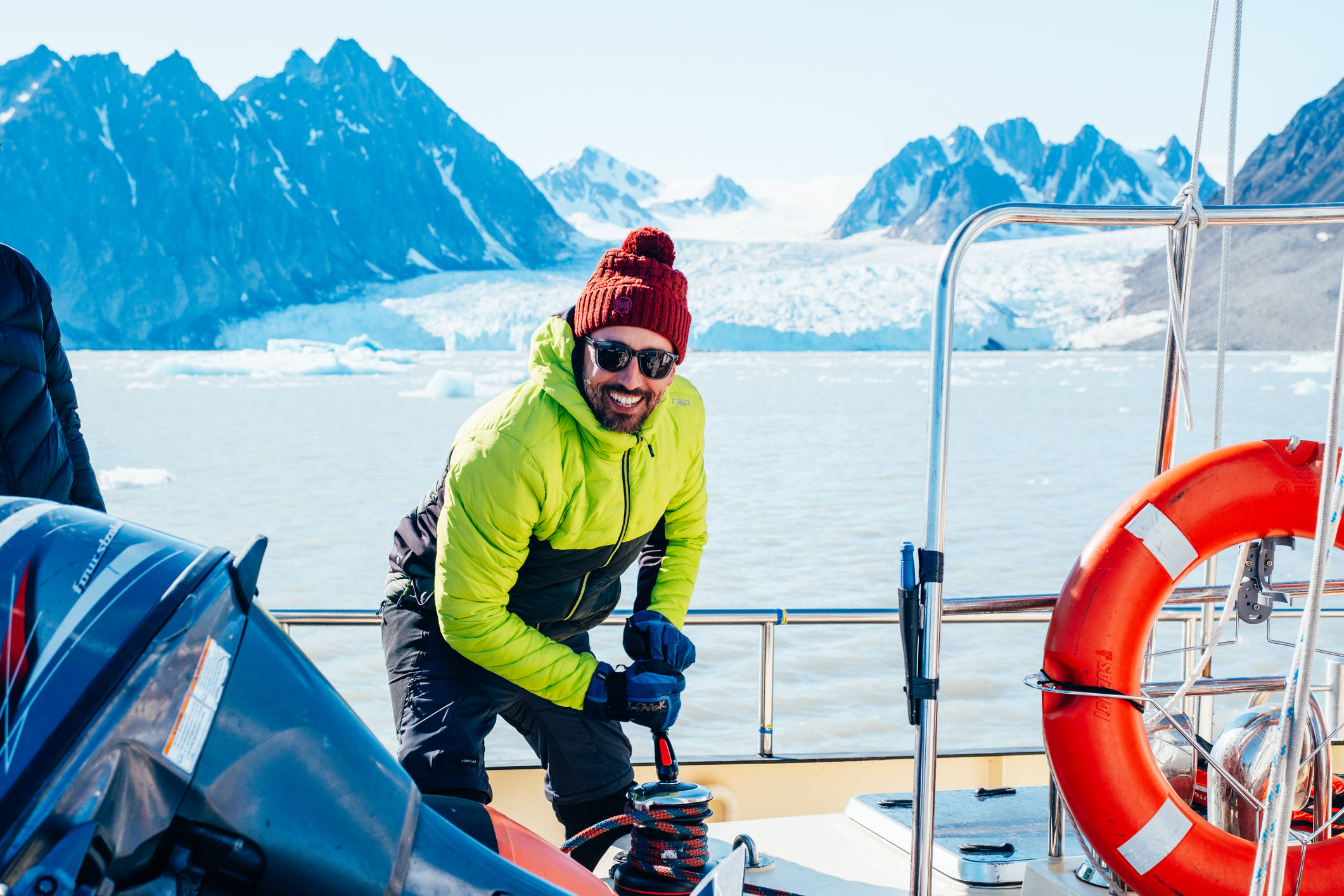 Man working the sails in the arctic on a boat