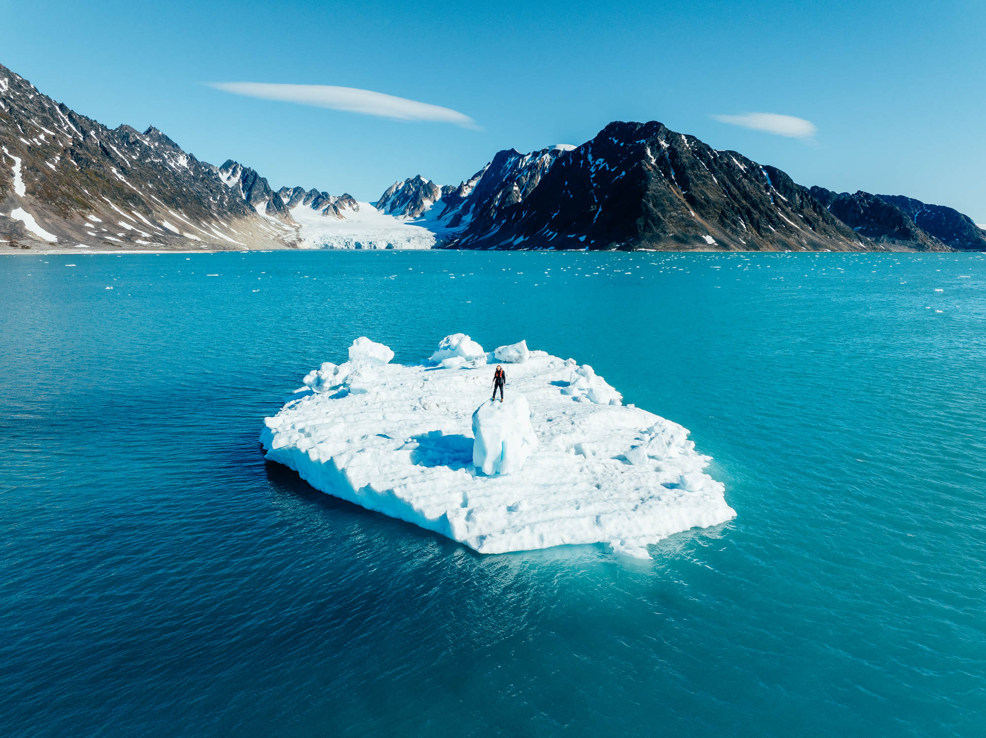 Man standing on an ice berg in the arctic