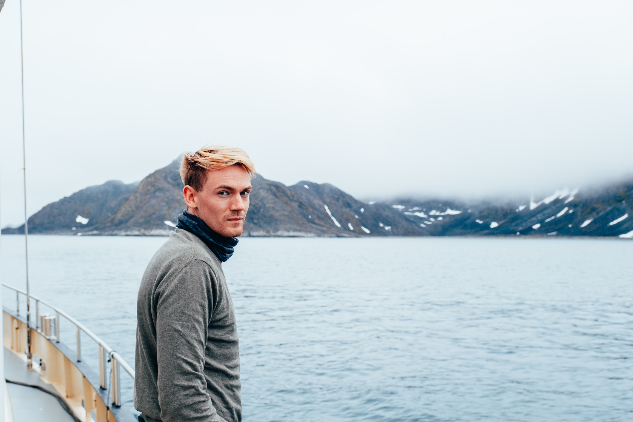 Portrait of a man standing on boat in norway