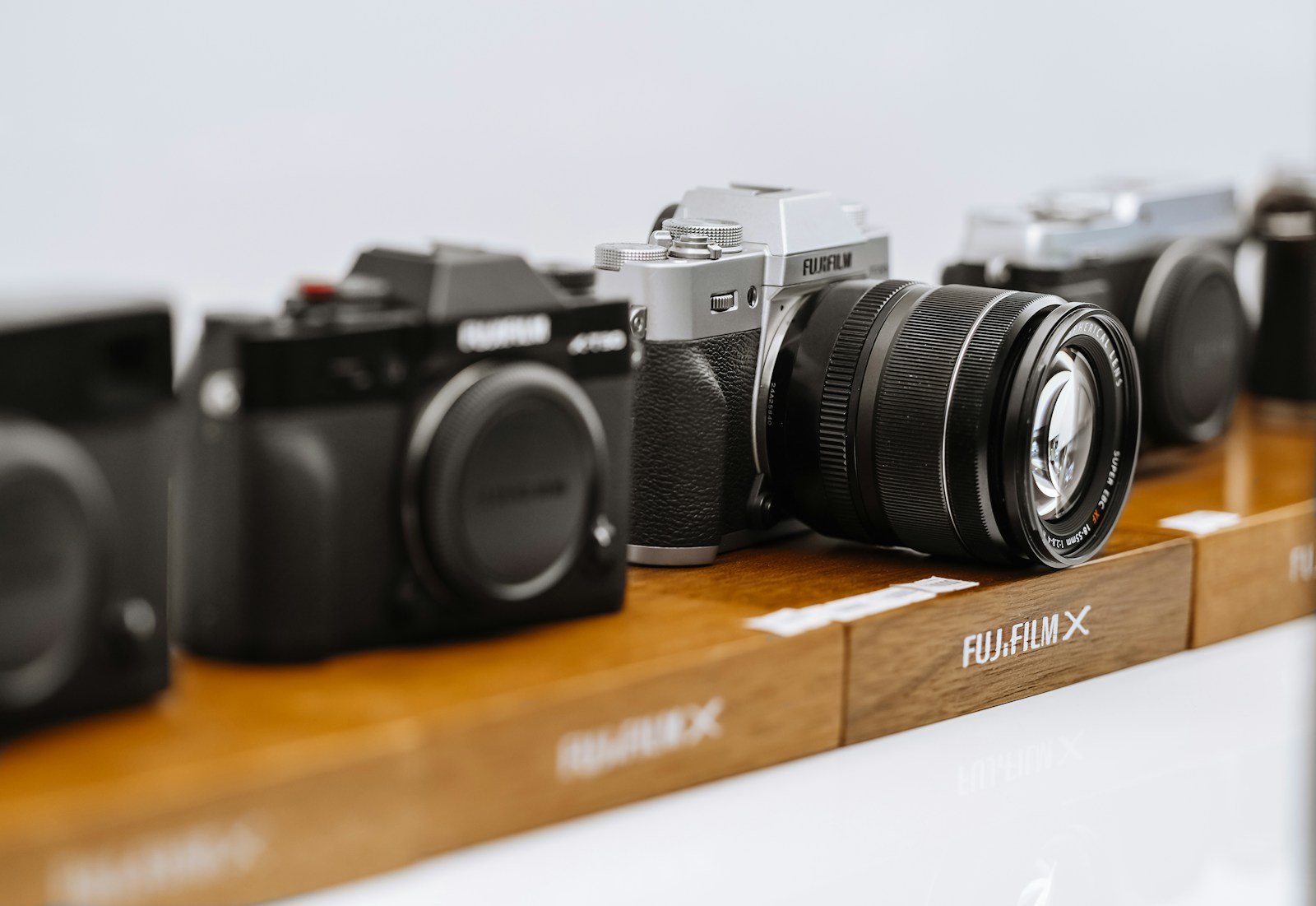 black and silver nikon dslr camera on brown wooden table