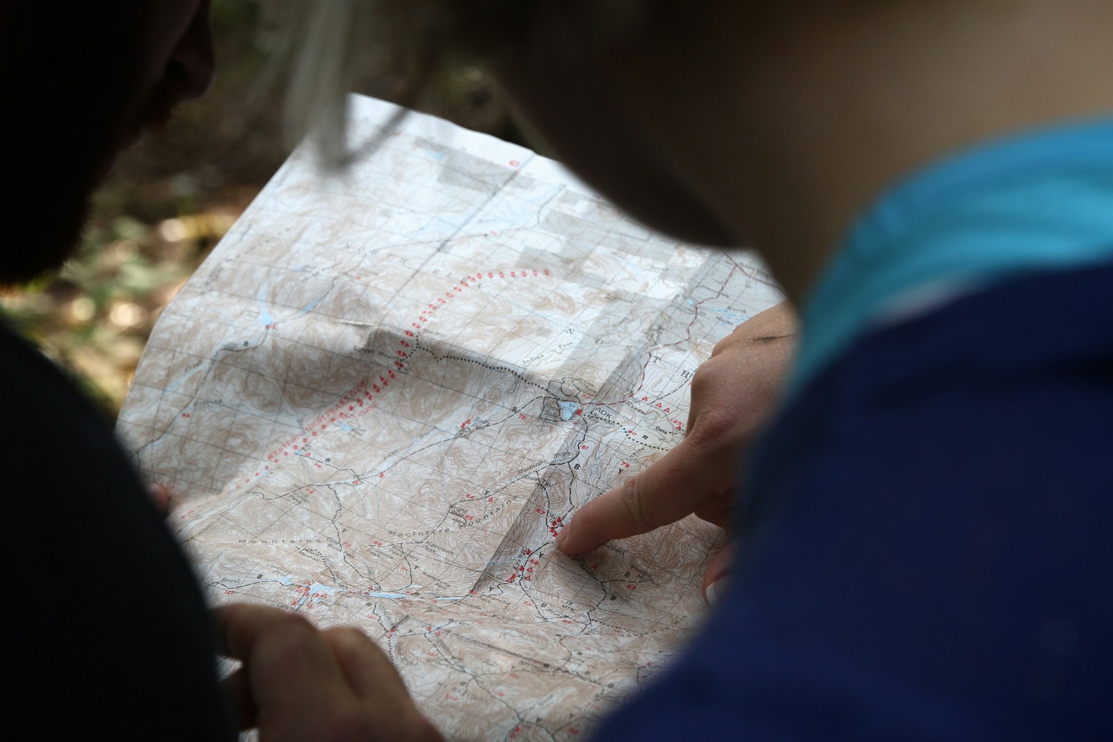 person pointing on beige map