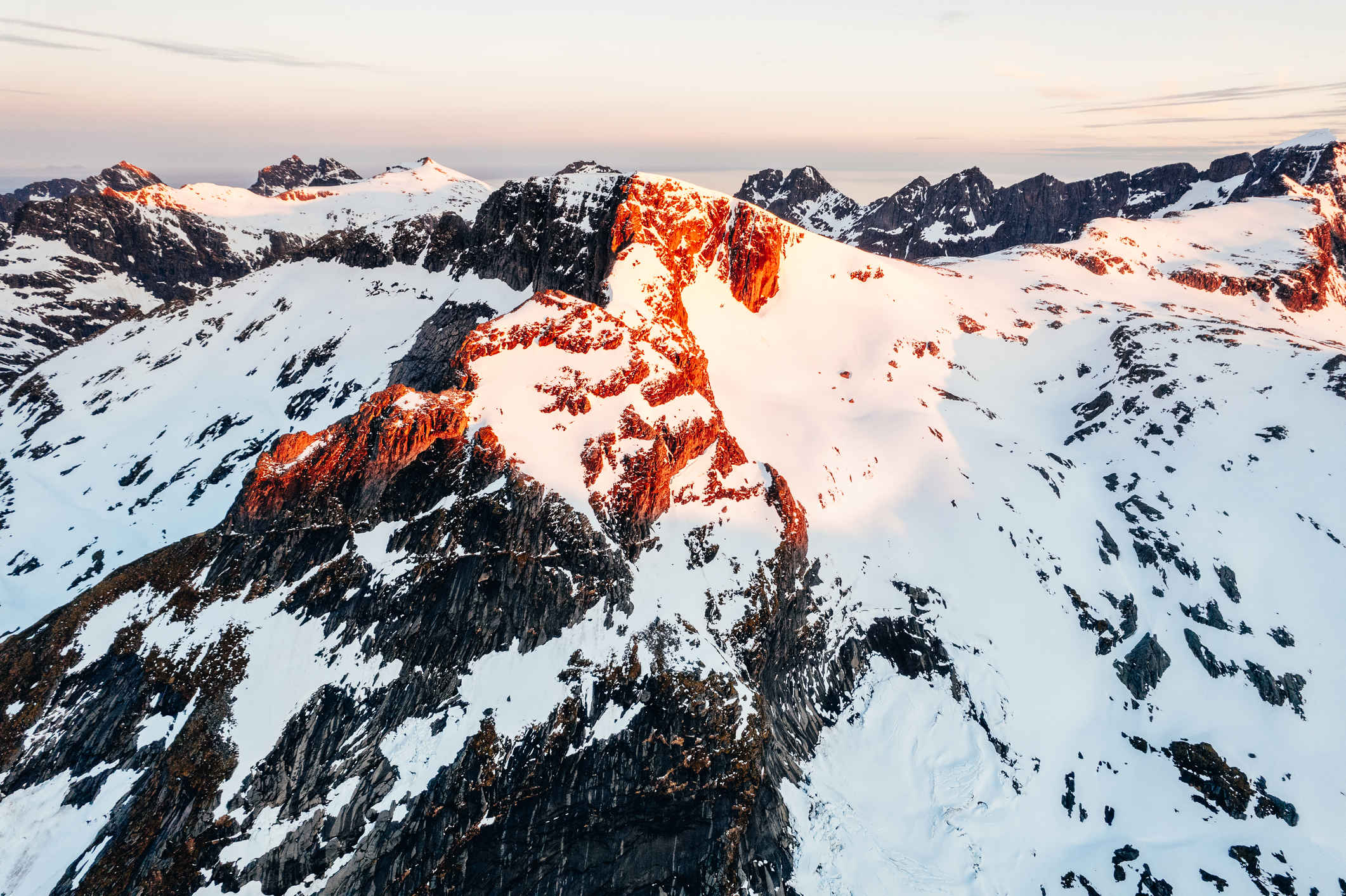 Snow covered peaks glowing in the sunrise