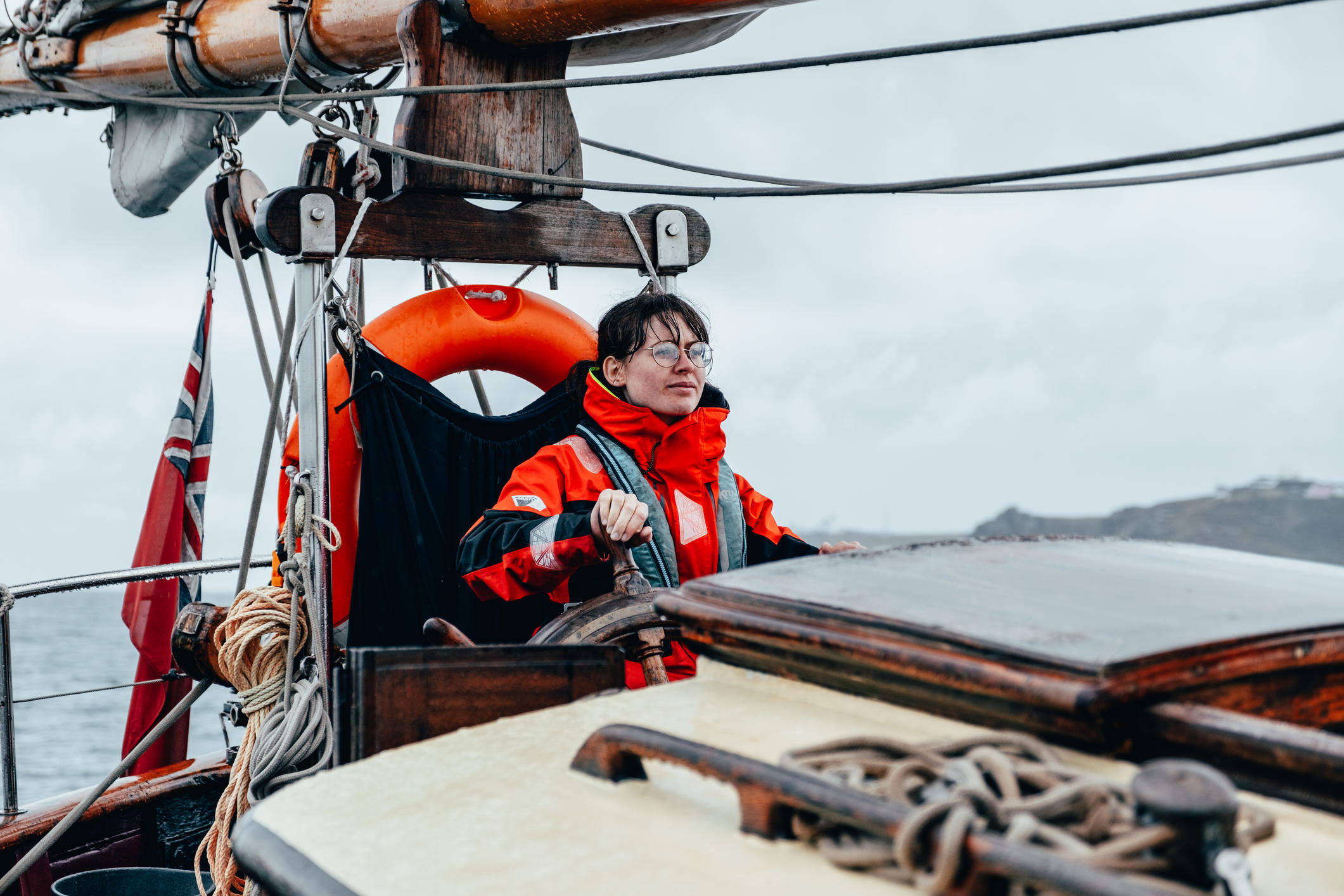 Woman at the helm on a tall ship