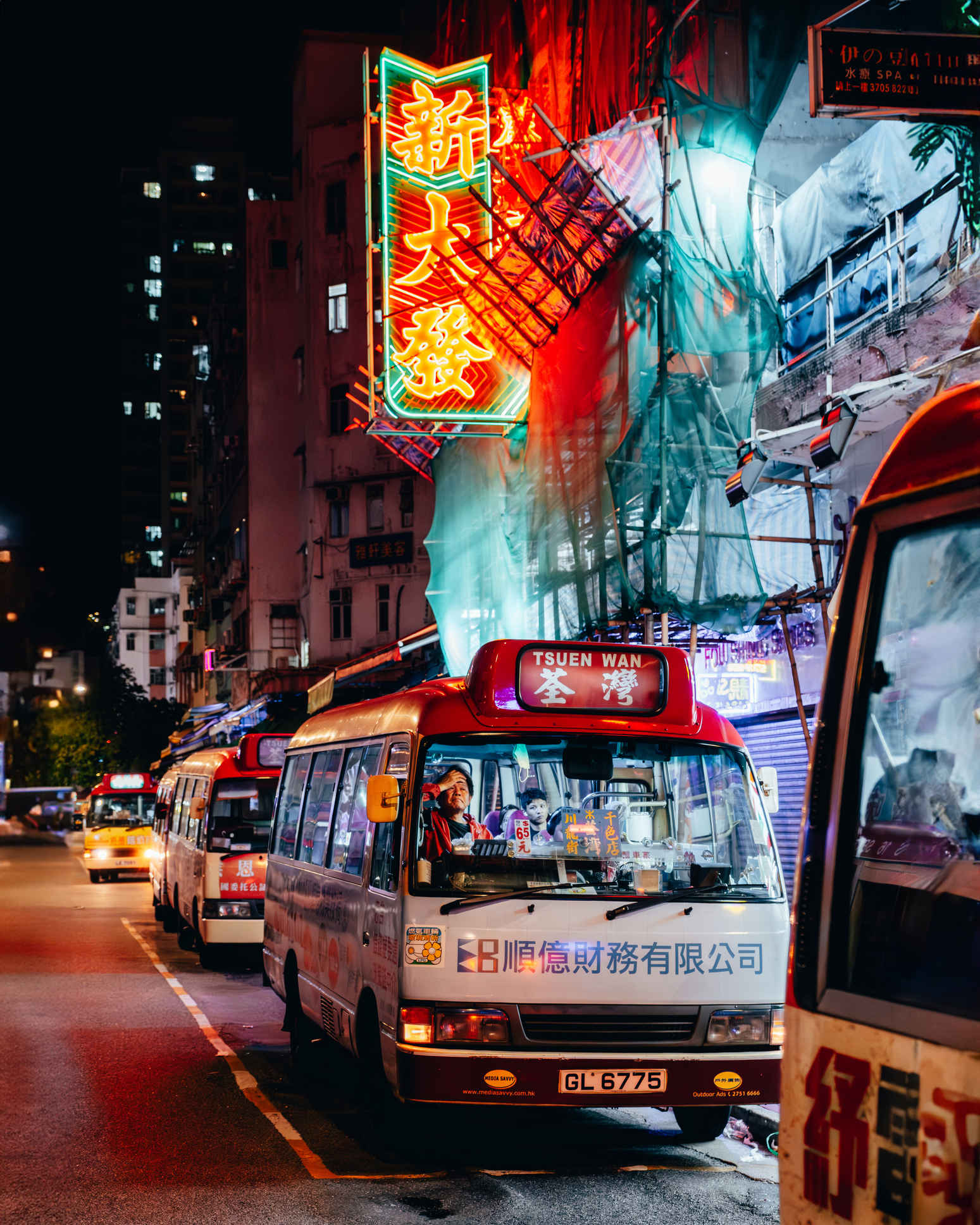 Man on a bus in Mong Kok Hong Kong at night