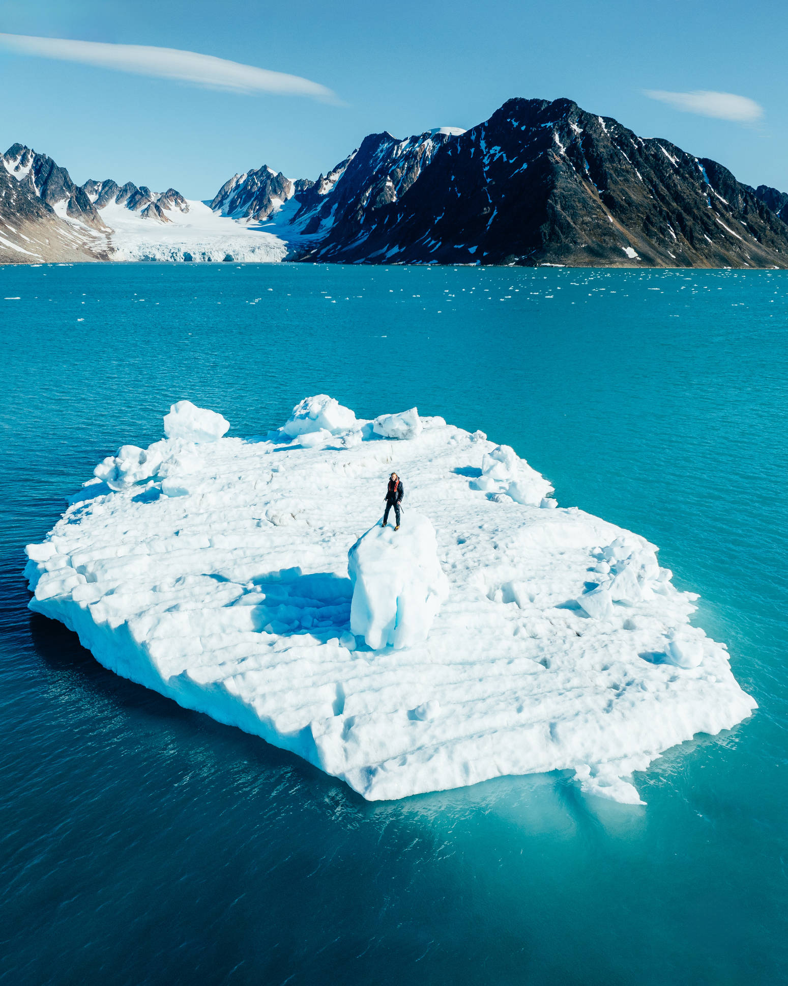 Man standing on an ice berg in the arctic
