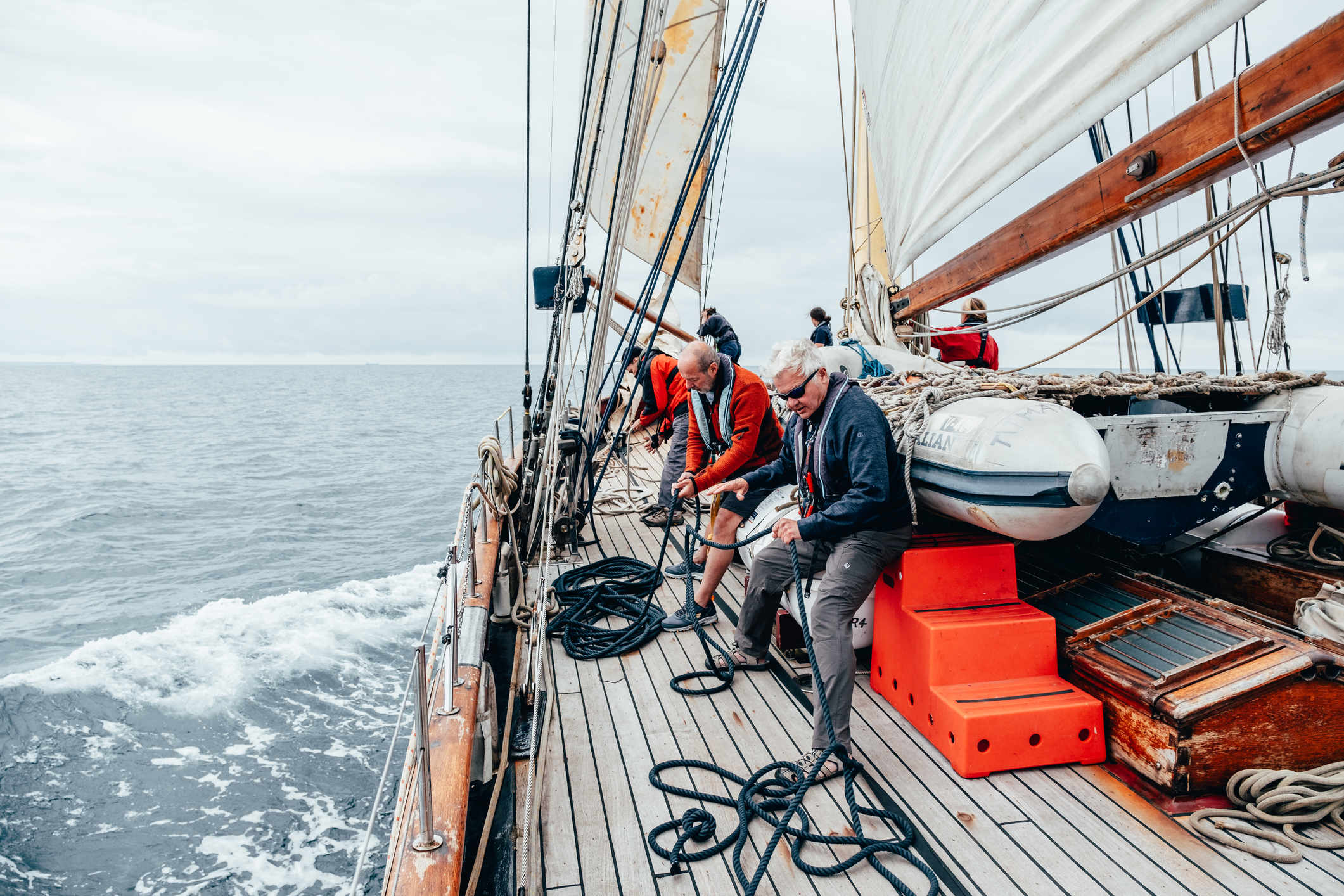 People working the sails on a tall ship