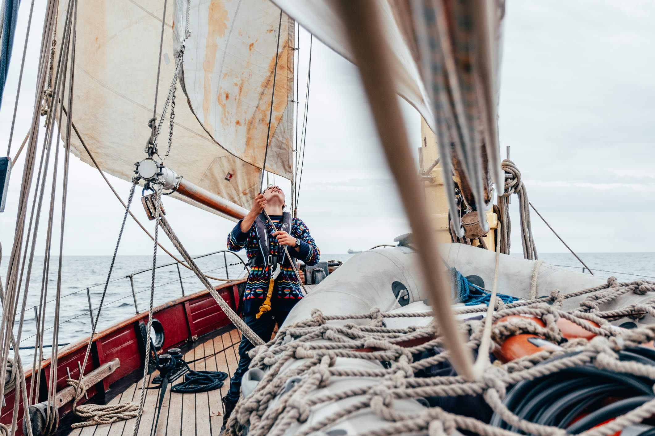 Woman working the ropes on a ship