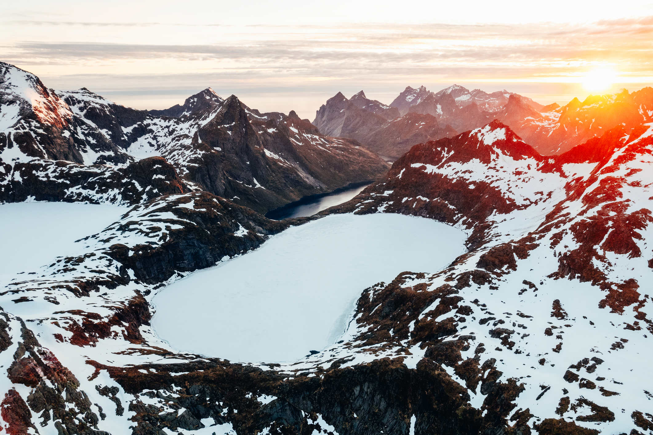 Sunrise over a snow covered mountain range in Lofoten