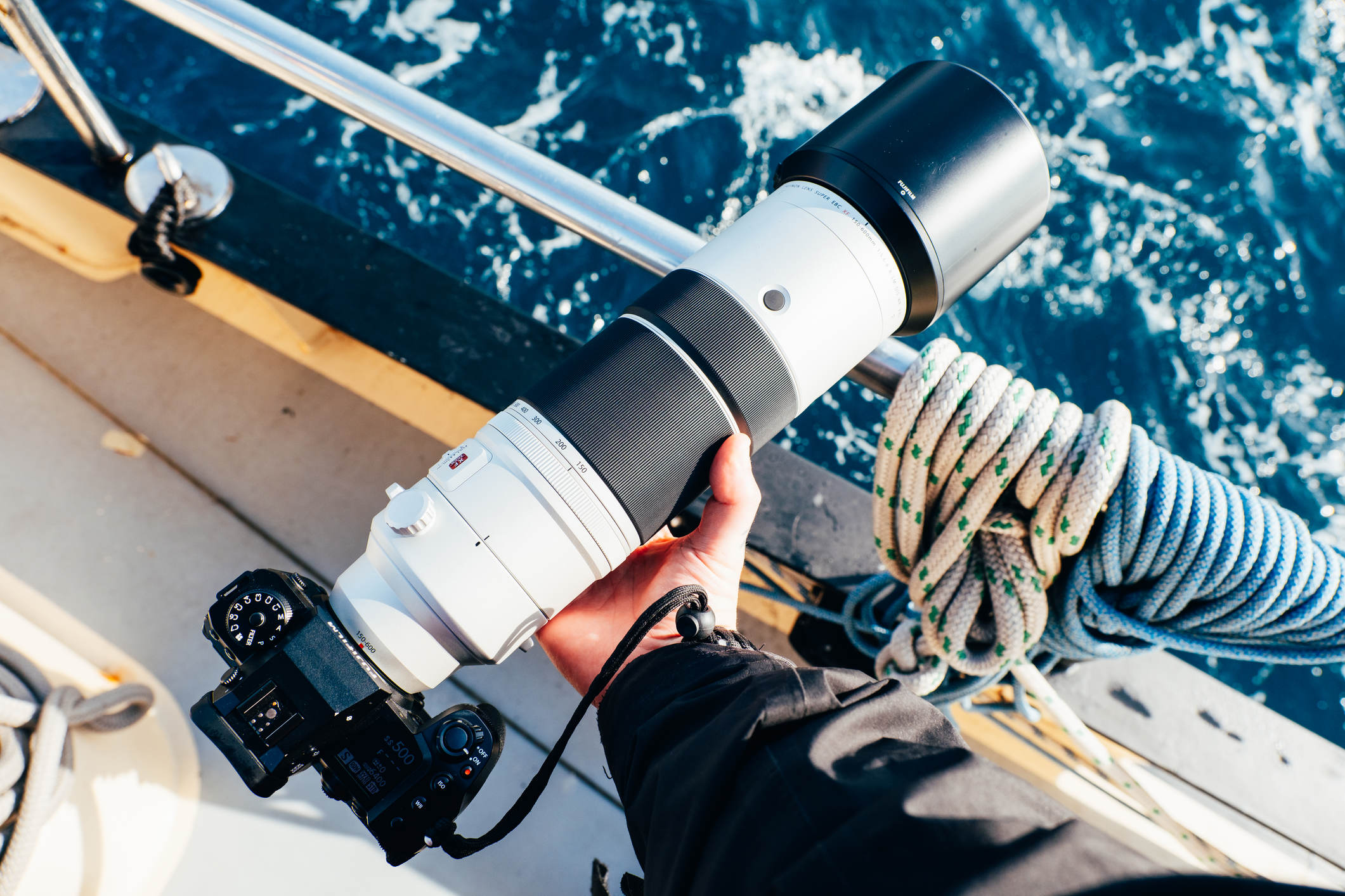 Fujifilm 600mm lens being held on a boat