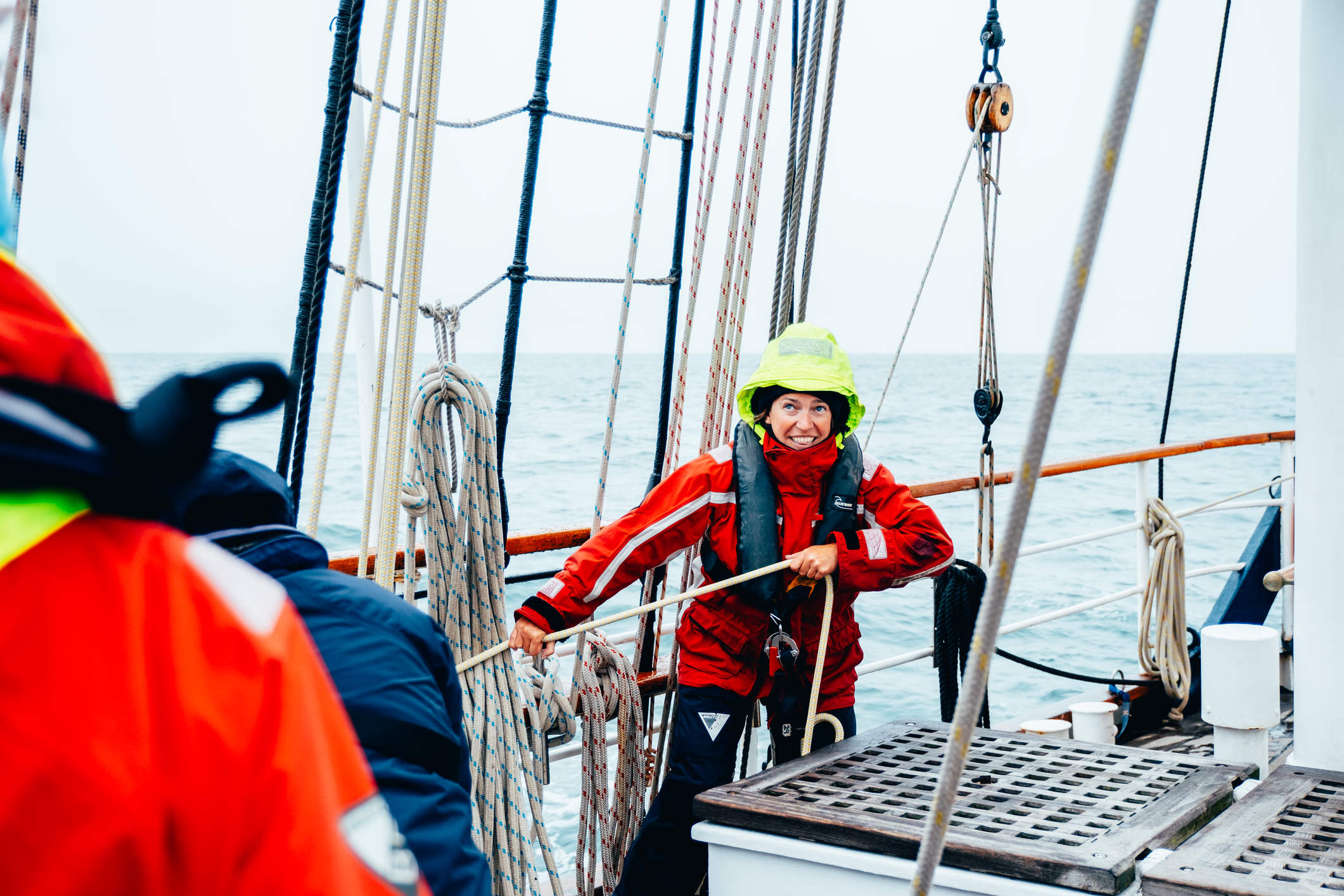 Woman working the ropes on a tall ship