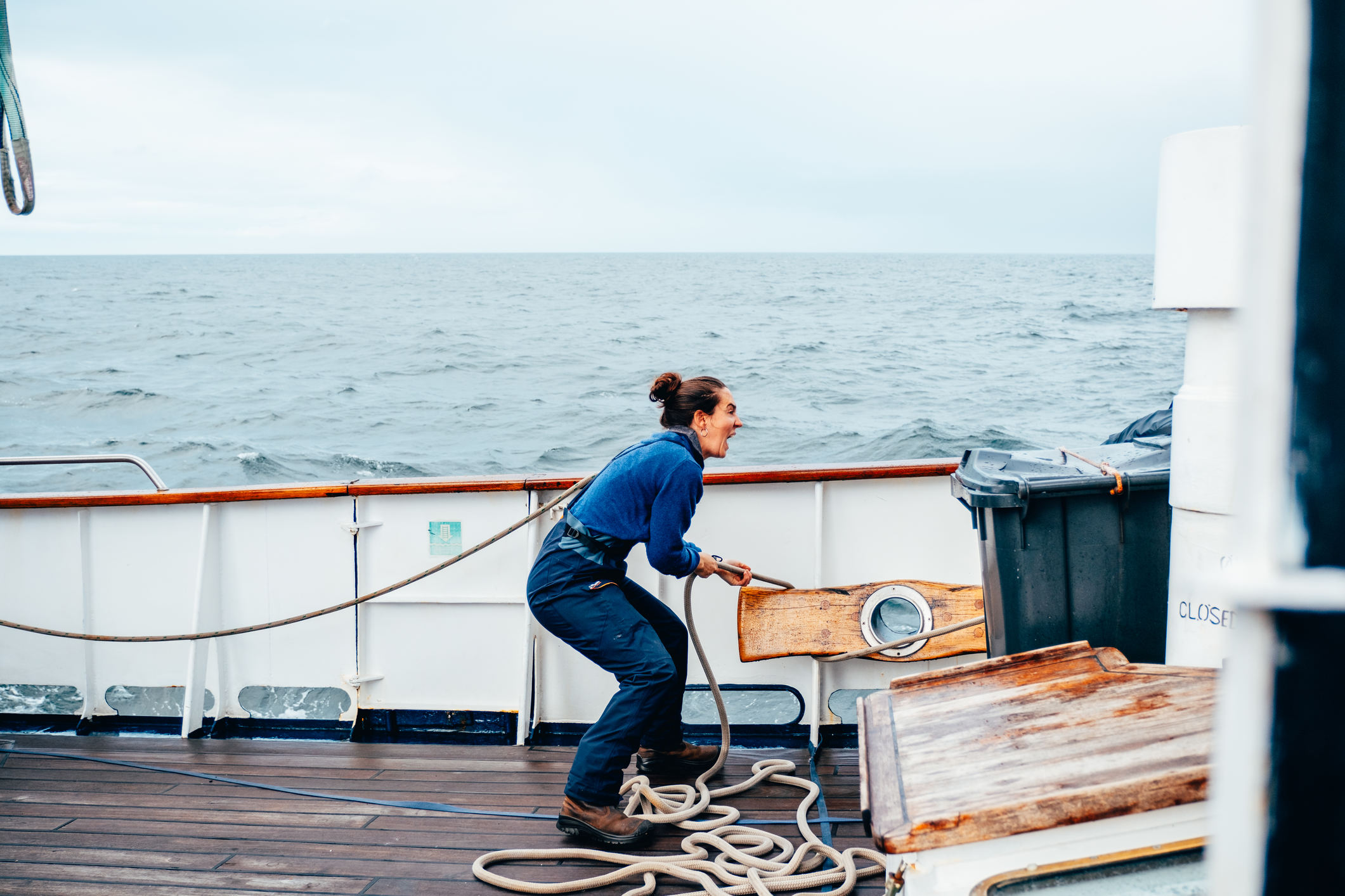 Woman working the ropes on a tall ship